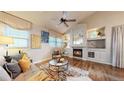 Inviting living room features hardwood floors, fireplace, and ample natural light from large windows at 2266 S Kenton St, Aurora, CO 80014