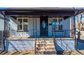 Inviting home exterior with a classic front porch, decorative railing, and a well-manicured front yard at 4059 Quivas St, Denver, CO 80211