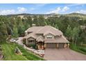 A beautiful, landscaped home featuring a three car garage and a stone walkway at 1456 Shavano Ct, Evergreen, CO 80439