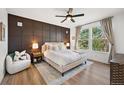 Comfortable main bedroom with large windows and a king-size bed with luxurious pillows at 1053 Snow Lily Ct, Castle Pines, CO 80108
