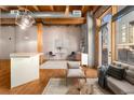 Open living space boasts exposed beams, hardwood floors, and natural light at 2960 Inca St # 308, Denver, CO 80202