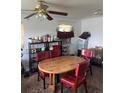 Inviting dining area with a wooden table, red chairs, and ample shelving for storage at 1132 Moline St, Aurora, CO 80010