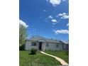 View of charming single-story home with a well-maintained lawn and inviting walkway under a bright blue sky at 1132 Moline St, Aurora, CO 80010