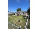Landscaped front yard of a cozy home with a chain-link fence and outdoor seating at 1132 Moline St, Aurora, CO 80010