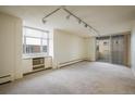 Bright, spacious living area with large windows and sliding glass doors to a balcony, perfect for relaxing at 850 20Th St # 203, Boulder, CO 80302