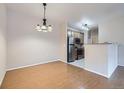 Dining space area with chandelier, wood floors and view of the stainless steel kitchen appliances at 5537 Lewis Ct # 4, Arvada, CO 80002