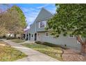 Lovely two-story home with landscaped front yard, sidewalk, and mature trees at 1915 S Balsam St, Lakewood, CO 80227