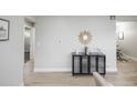 Neutral decor hallway showcasing a view into multiple rooms with hardwood flooring at 740 Moline St, Aurora, CO 80010