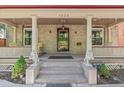 Inviting front porch with lion statues, columns, and space for relaxing in the shade at 1226 Clayton St, Denver, CO 80206
