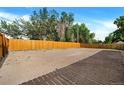 Large, empty backyard with a wooden fence and plenty of space for activities at 7380 Utica St, Westminster, CO 80030
