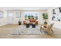 Bright living room with a large bay window, modern decor, and neutral tones for a welcoming ambiance at 7380 Utica St, Westminster, CO 80030