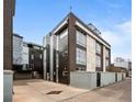 Modern multi-level building with dark brick and silver metal, located in a vibrant urban neighborhood at 2539 Lawrence St, Denver, CO 80205