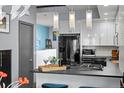 Bright kitchen featuring white cabinets, modern pendant lighting, and sleek countertops for a contemporary feel at 2539 Lawrence St, Denver, CO 80205