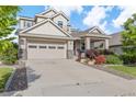 Charming two-story home featuring a two-car garage and a beautifully landscaped front yard with lovely plants at 5077 W 108Th Cir, Westminster, CO 80031