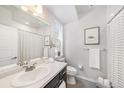 Neutral bathroom featuring a shower-tub combo and dark vanity at 522 Meridian Ln, Superior, CO 80027