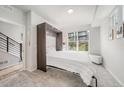 Clean bedroom with white murphy bed, large window, and neutral decor at 522 Meridian Ln, Superior, CO 80027