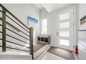 Bright entryway with storage bench, white door with glass panes, and modern staircase at 522 Meridian Ln, Superior, CO 80027