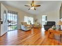 Inviting living room with hardwood floors, comfortable seating, and an open entrance with natural light at 675 S Quivas St, Denver, CO 80223
