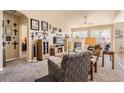 Inviting living room featuring a fireplace, ceiling fan, and neutral decor at 6694 S Rome St, Aurora, CO 80016