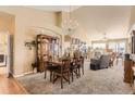 Spacious living room with a fireplace, chandelier, carpet, and high ceilings at 6694 S Rome St, Aurora, CO 80016