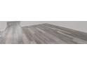Neutral room with gray wood-look flooring, white walls and baseboards ready for personalization at 19466 E 59Th Dr, Aurora, CO 80019
