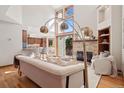 Open-concept living area with a vaulted ceiling, gas fireplace, and views of the kitchen at 31402 N Bermuda Dunes Dr, Evergreen, CO 80439