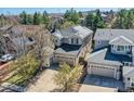 An aerial view showcases a home with a three-car garage and solar panels at 10908 Oakshire Ave, Highlands Ranch, CO 80126