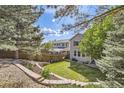 A nicely landscaped backyard featuring a retaining wall and view of home at 10908 Oakshire Ave, Highlands Ranch, CO 80126