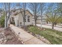 Charming home exterior with a landscaped walkway, mature trees, and well-manicured lawn at 10908 Oakshire Ave, Highlands Ranch, CO 80126