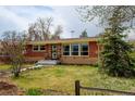 Lovely brick home with a well-kept lawn and mature landscaping at 345 Central Ave, Brighton, CO 80601