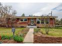 Charming brick home with a manicured front yard and inviting walkway at 345 Central Ave, Brighton, CO 80601