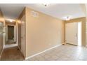 Inviting foyer featuring neutral paint, tile flooring, and hallway access at 16141 W 64Th Way, Arvada, CO 80007
