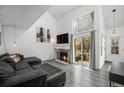 Open living room features a cozy fireplace, large windows, and sliding doors to the patio at 2005 S Helena St # G, Aurora, CO 80013