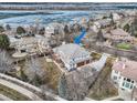 Spacious home with a three-car garage and deck overlooking a partially frozen lake at 6790 W Crestline Ave, Littleton, CO 80123