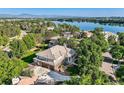 Wonderful aerial view of a luxury home in a lakeside community with mature trees at 6790 W Crestline Ave, Littleton, CO 80123