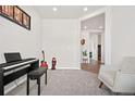 Cozy bonus space showcasing neutral carpet and décor for versatile use as a living room, office, or playroom at 9248 Salida St, Commerce City, CO 80022
