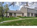 Inviting home featuring well-kept lawn, brick facade, and welcoming front entrance, complemented by mature trees at 4323 W Ponds Cir, Littleton, CO 80123