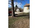 View of the concrete driveway and damaged back of the property at 1165 S Winona Ct, Denver, CO 80219