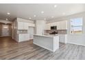 Bright kitchen features white cabinets, a center island, and stainless steel appliances at 25023 N 34Th Ave, Aurora, CO 80019