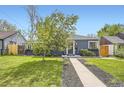 Attractive home exterior boasting a lush green lawn and a inviting walkway at 2540 Kendall St, Edgewater, CO 80214