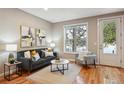 Bright living room featuring a comfortable sofa, stylish decor, and a large window at 3482 E 28Th Ave, Denver, CO 80205