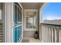 Welcoming front porch with a secure screen door and view to the home's interior at 8406 Pebble Creek Way # 202, Highlands Ranch, CO 80126