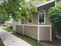 Townhouse featuring a cozy, fenced patio area with well-maintained landscaping at 5898 W Asbury Pl, Lakewood, CO 80227