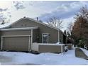 Exterior view of a cozy home, complete with a fenced yard, and attached garage at 5898 W Asbury Pl, Lakewood, CO 80227