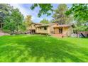 Expansive backyard with lush lawn, deck, and patio offers ample outdoor living space at 8866 E Easter Ave, Centennial, CO 80112