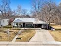 Charming single story home with a covered carport, front porch, and a well-maintained yard at 3145 S Ash St, Denver, CO 80222