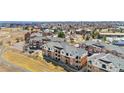 Expansive aerial view showcases the beautiful brick townhomes in a well-designed community with stunning city views at 8944 Fox Dr # 6-103, Denver, CO 80260