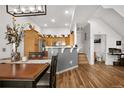 Open kitchen featuring a breakfast bar, stainless steel appliances and wood cabinets at 8944 Fox Dr, Denver, CO 80260