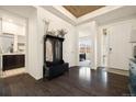 Bright foyer featuring hardwood floors, a coat rack, and a view into the home at 16034 Columbine St, Thornton, CO 80602