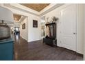 Inviting foyer with wood floors, tray ceiling, and a convenient coat rack at 16034 Columbine St, Thornton, CO 80602